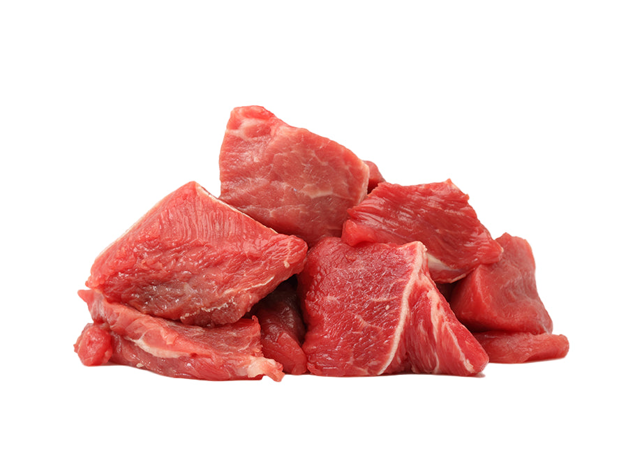 Raw beef chunks on a white background